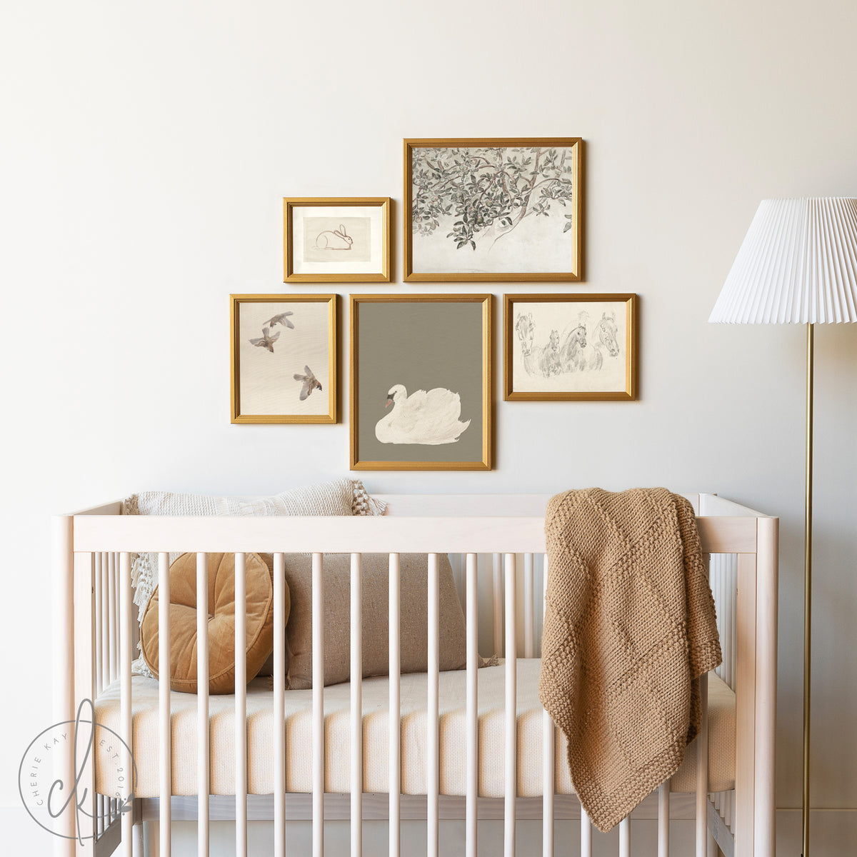 A nursery gallery wall art is displayed above a crib, featuring a curated set of vintage animal and nature prints, including a swan, rabbit, birds, tree branches, and horses. Perfect for kids&amp;#39; rooms, nurseries, or playrooms with an elegant design.