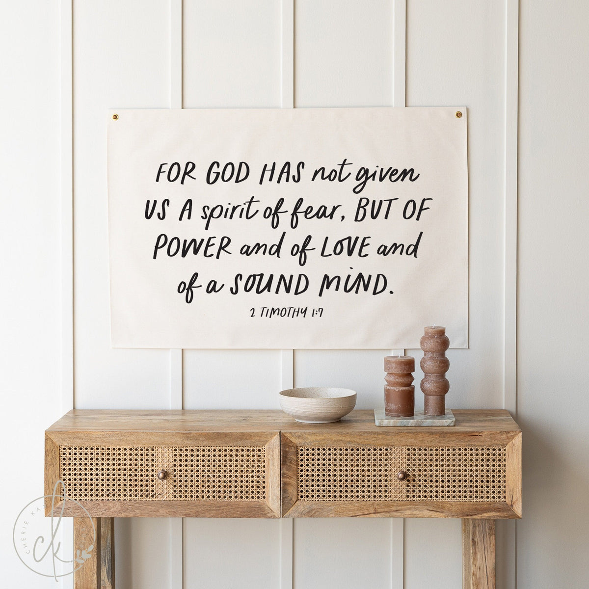 Inspirational Bible Verse Canvas Flag with the text &amp;quot;For God has not given us a spirit of fear, but of power and of love and of a sound mind&amp;quot; from 2 Timothy 1:7, displayed above a rustic wooden console table with decorative items.