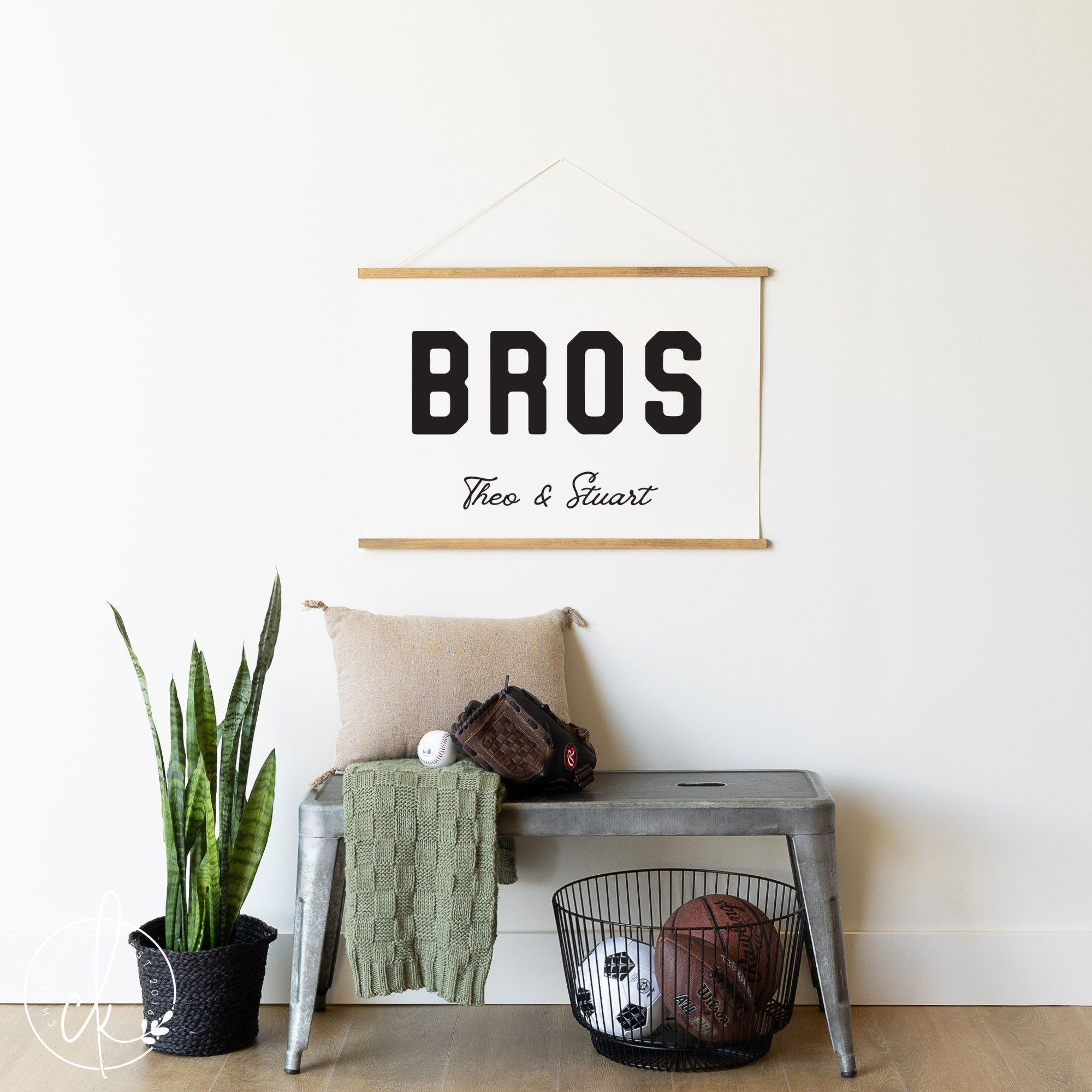 Personalized Bros wall art sign with custom names Theo & Stuart displayed above a metal bench with sports equipment and a plant, perfect for nursery, playroom, or bedroom decor.