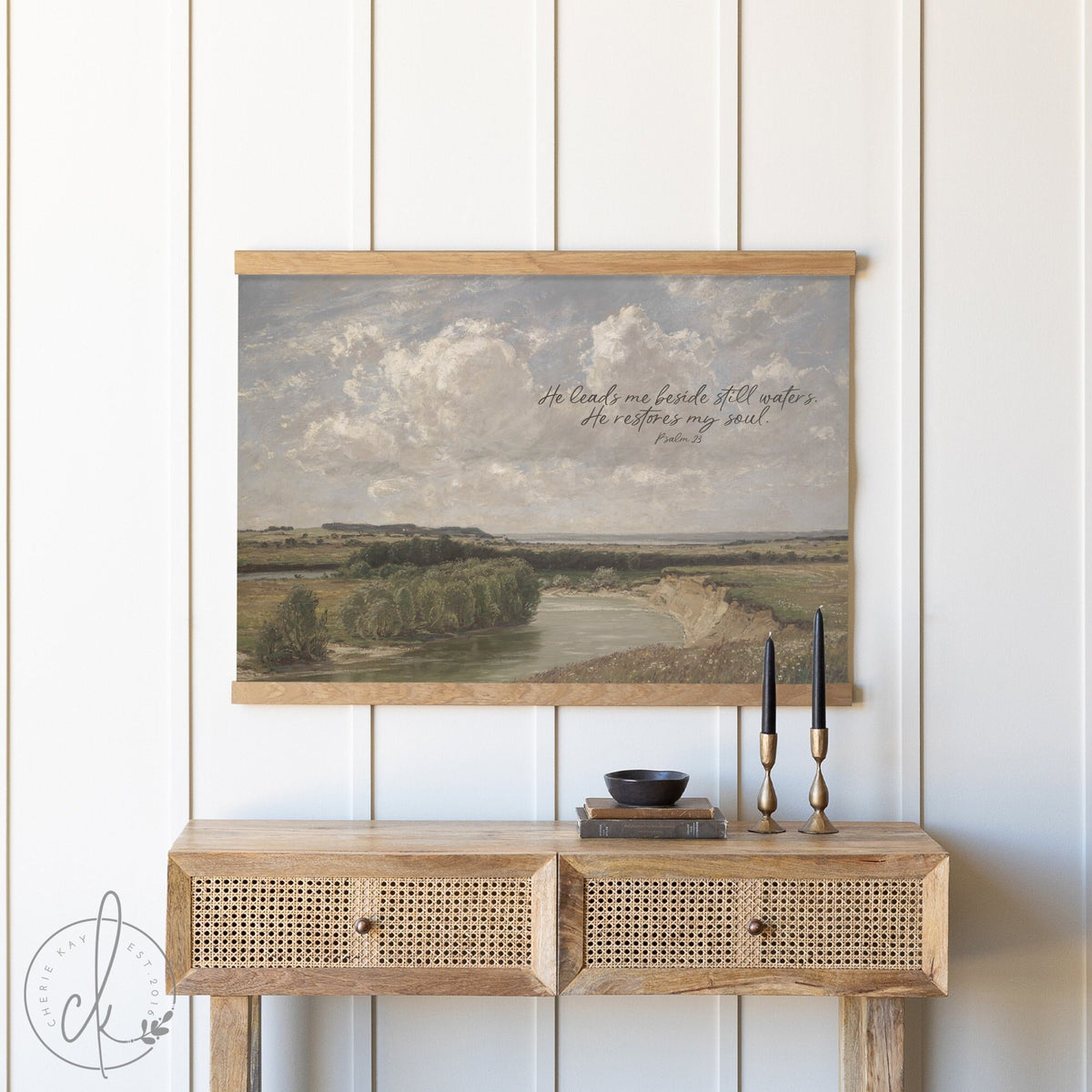 Canvas tapestry with a landscape painting featuring a river, trees, and an expansive sky. The tapestry is illustrated with the text &amp;#39;He leads me beside still waters. He restores my soul.&amp;#39; from Psalm 23.