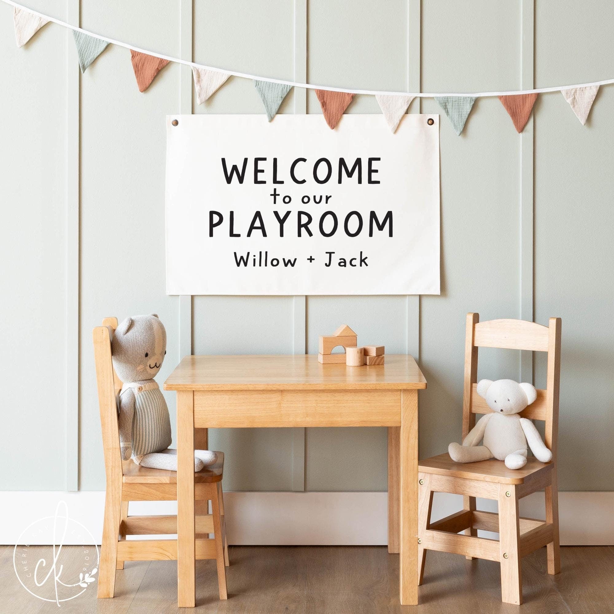 Personalized playroom wall decor sign with WELCOME to our PLAYROOM and custom names displayed in a cozy kids room with wooden furniture and soft toys, perfect for children&#39;s playroom or nursery decor.