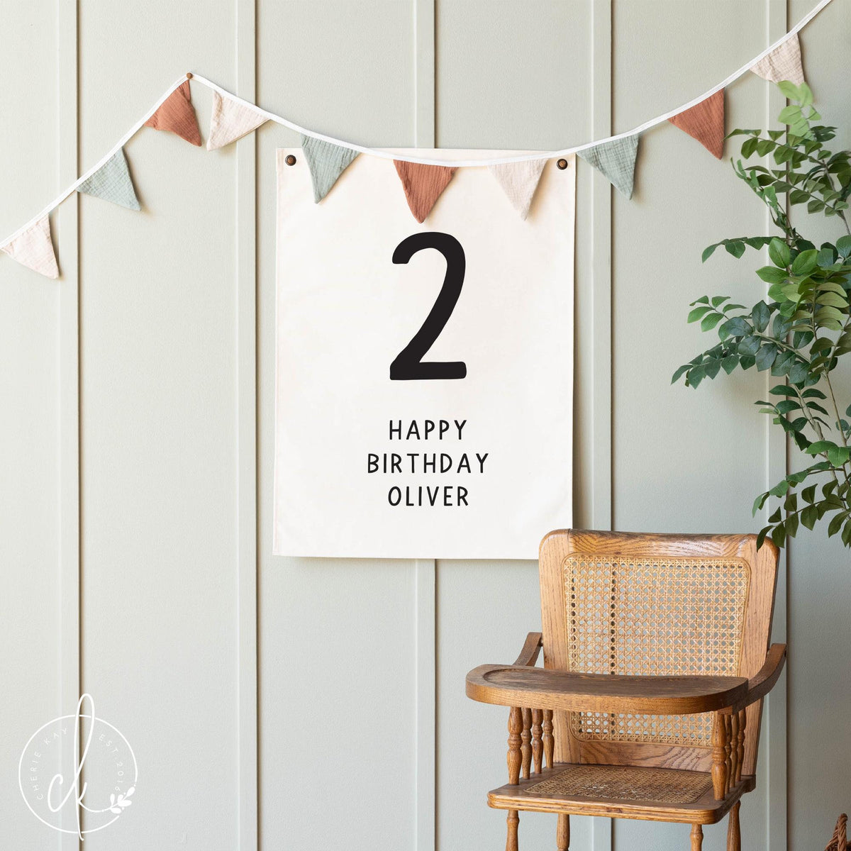 Personalized Happy Birthday canvas flag for kids. The custom banner features bold black text on a neutral canvas backdrop. Perfect for children&amp;#39;s birthday party decor, nursery wall art, or a special photo backdrop.