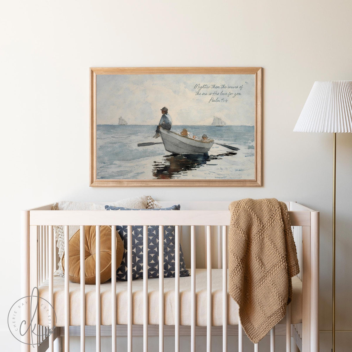 Nursery with a wooden crib and coastal-themed decor, featuring a vintage seascape art print of a fisherman and children in a boat with a Psalm 93:4 quote above.