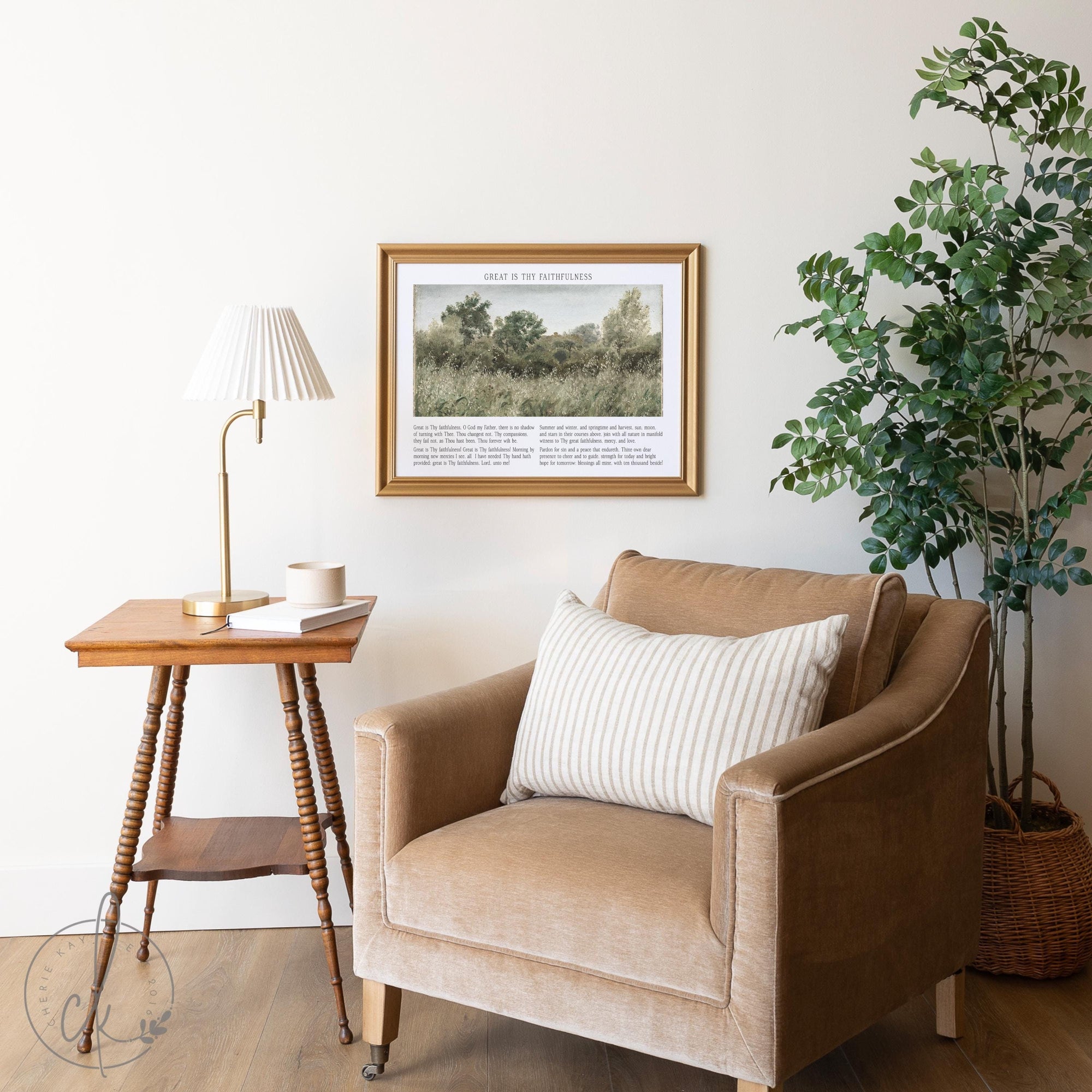 Living room with framed - Great Is Thy Faithfulness - art above a beige armchair, side table, lamp, and potted plant.