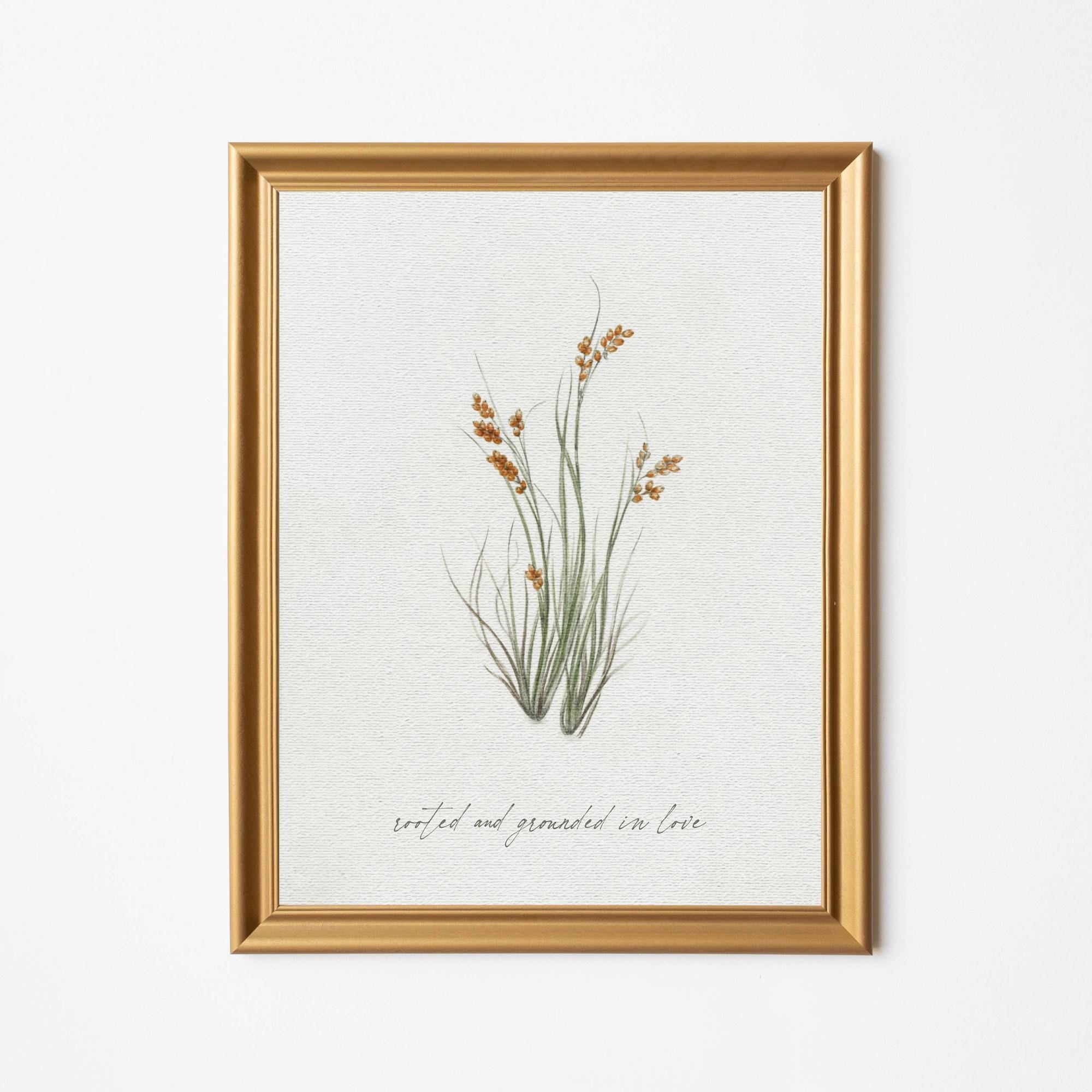 Gold-framed botanical wall art featuring delicate wildflowers with the text Rooted and Grounded in Love is perfect for Christian inspirational home decor, living rooms, bedrooms, or offices.