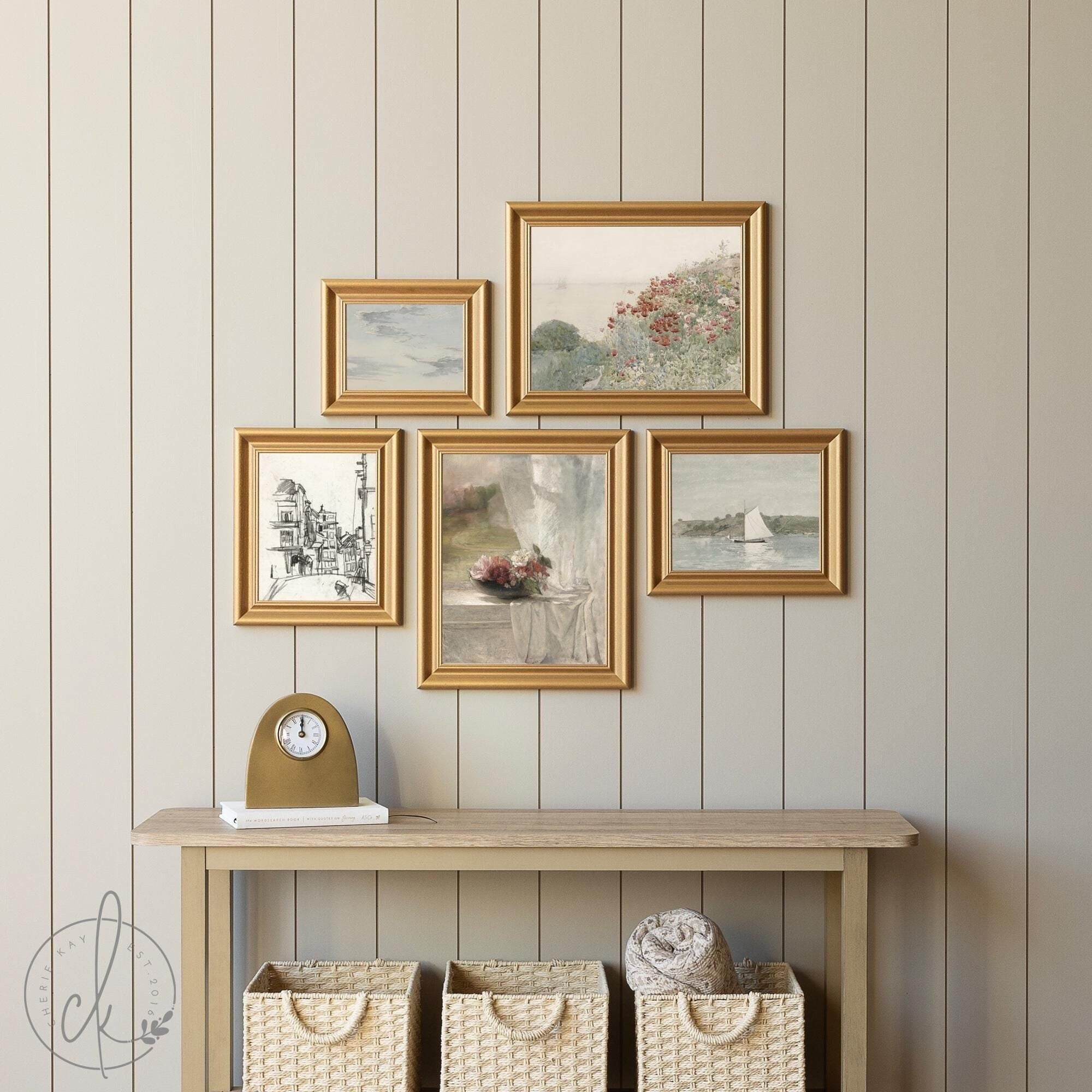 A 5-piece vintage-inspired gallery wall art set in coordinating gold frames featuring a coastal scene, botanical blooms, a city sketch, a sailboat on calm waters, and a romantic still life with flowers.